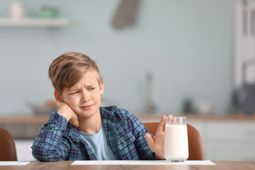 Little boy with dairy allergy in kitchen