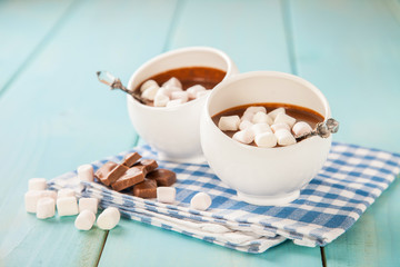 hot chocolate with marshmallows in a cup on a wooden table, selective focus, copy space
