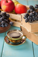coffee in a cup, grapes and apples on a table, selective focus, copy space