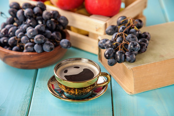 coffee in a cup, grapes and apples on a table, selective focus, copy space