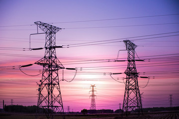 High voltage power cord. Sub-station. High voltage transmission tower. A distribution substation with power lines and transformers.