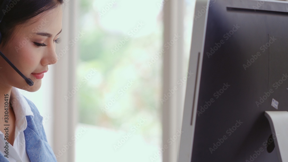 Aufkleber customer support agent or call center with headset works on desktop computer while supporting the cu