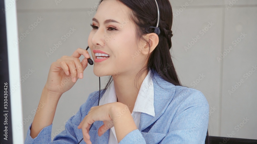 Aufkleber customer support agent or call center with headset works on desktop computer while supporting the cu