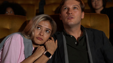 People audience watching movie in the movie theater cinema. Group recreation activity and...
