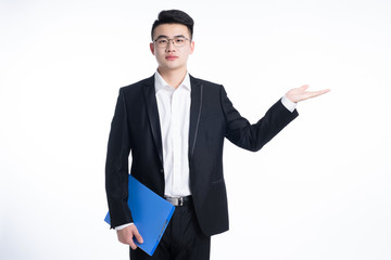 A young Asian man is using his mobile phone and laptop