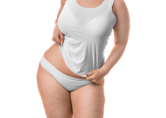Fat woman showing her waist - isolated over white background.