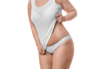 Close up photo of a fat woman showing her waist - isolated over white background.