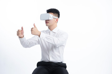 A young Asian man is using his mobile phone and laptop