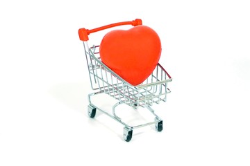 Red heart shape in a shopping cart on a white background. Heart Love Valentine's day Concept.