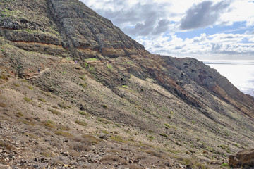 Scenic view of mountain and hills of Point of Saint Lawrence (Ponta de São Lourenço) - the easternmost point of the island of Madeira. Cloudy look of landscape of tropical island in Atlantic ocean