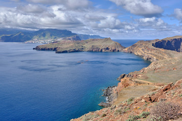 Fototapeta premium Scenic view of mountain and hills of Point of Saint Lawrence (Ponta de São Lourenço) - the easternmost point of the island of Madeira. Cloudy look of landscape of tropical island in Atlantic ocean