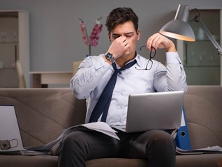 Businessman workaholic working late at home