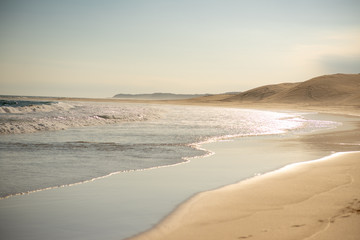 Landscape shot of coastline with crashing waves