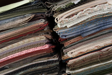stack of pieces fabric many pattern on shelf, material recycle for clothing fashion design
