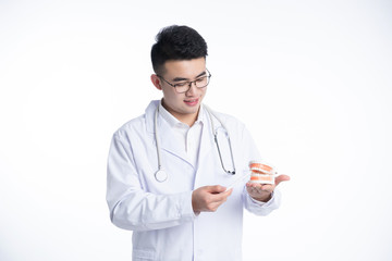 Fototapeta premium An Asian male doctor works on a laptop