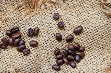 Coffee beans. on old bag texture background.
