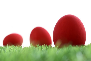 red easter egg on lawn green grass artificial with blank white background