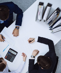 Business people at meeting, view from above. Bookkeeper or financial inspector making report,...