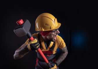the male construction worker with a sledgehammer