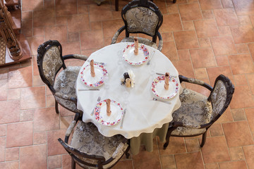 Beautiful table setting with white tablecloth and plates.