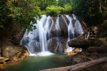 waterfall clear water and green emerald for nature holiday relax and summer vacation travel with tree and stone or rock in forest at nang khruan waterfall 2nd floor in lam khong ngu national park