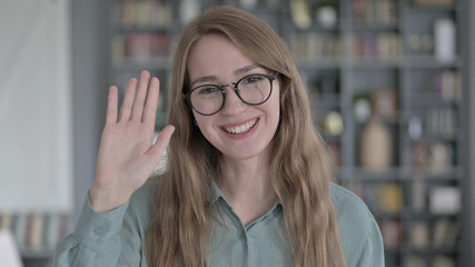 The Portrait of Young Woman Waving and Talking in Office