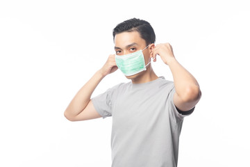 Young Asian Man wearing hygienic mask to prevent infection, 2019-nCoV or coronavirus. Airborne respiratory illness such as pm 2.5 fighting and flu. Studio shot isolated on white background.