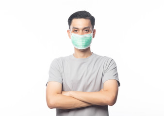 Young Asian Man wearing hygienic mask and arms crossed to prevent infection, 2019-nCoV or coronavirus. Airborne respiratory illness such as pm 2.5 fighting and flu. isolated on white background.