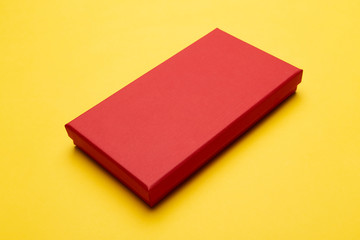 Red box product packaging isolated on yellow background.