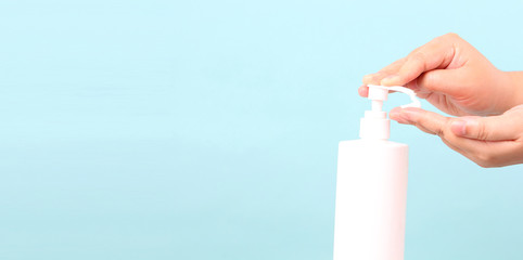 Suggest how toHands to lotion.isolated on blue background in studio With copy space.