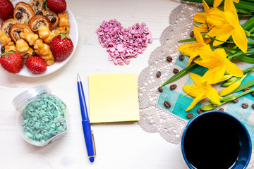 strawberry, cookie hearts with a Cup of grain black coffee, with yellow flowers and a leaf for a note with a Valentine's day mother woman Easter day
