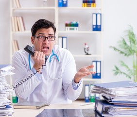 Busy doctor with too much work in hospital