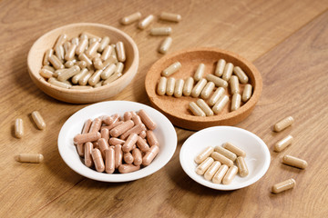 herbal pills on wooden background