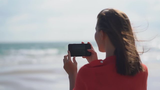 Beautiful girl on the beach taking photo of on Tropical Beach 4k resolution