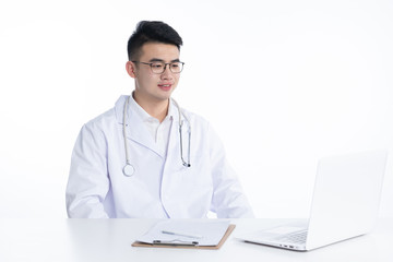 Fototapeta premium A young Asian doctor is using a device