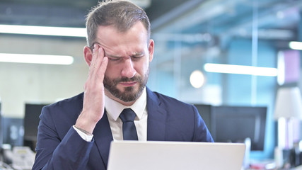 The Portrait of Businessman having Headache in Office