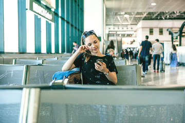 A tourist or student is waiting for a boarding announcement at a Milan airport in Italy to leave...