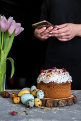 Easter composition with sweet bread, kulich and eggs on light background.