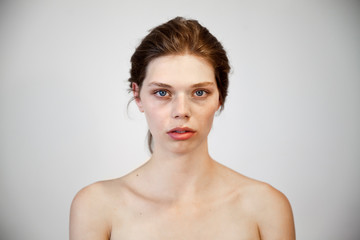 Fototapeta premium portrait of a beautiful natural girl with a clean healthy skin over white background.