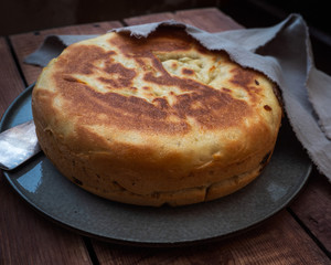 Freshly baked home piprog under a home napkin on a gray ceramic plate standing