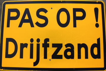 warning sign in  yellow and black for quick sand