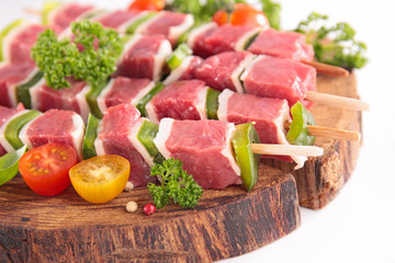 raw beef for barbecue-beef skewer, bell pepper and tomato on wooden board