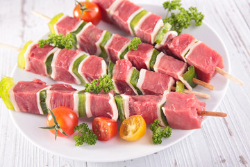 raw beef for barbecue-beef skewer, bell pepper and tomato on wooden board