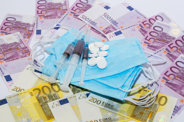 Tablets, protective mask, syringe and euro bills. Expensive medicine concept.