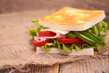 sandwich with avocado, tomato, cheese, ham and lettuce