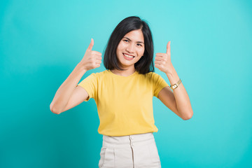Fototapeta premium Portrait Asian beautiful young woman standing, She made finger thumbs up