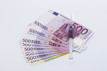 Syringe vaccine and euro bills. Expensive medicine concept.