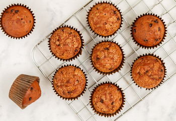 Homemade banana muffins with chocolate chips and salted caramel on a marble background. Delicious and healthy dessert for Breakfast. Selective focus, top view