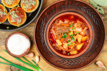 Borsch. Traditional Russian or Ukrainian red soup with beef and vegetables-beet, potato, carrot, cabbage, onion, fresh herbs and spices. Served with garlic pampushkas and sour cream. Selective focus