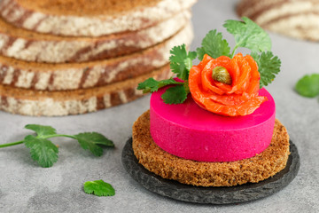 Beetroot and cream cheese (ricotta) mousse with salted salmon, fresh herbs and capers on slices of...
